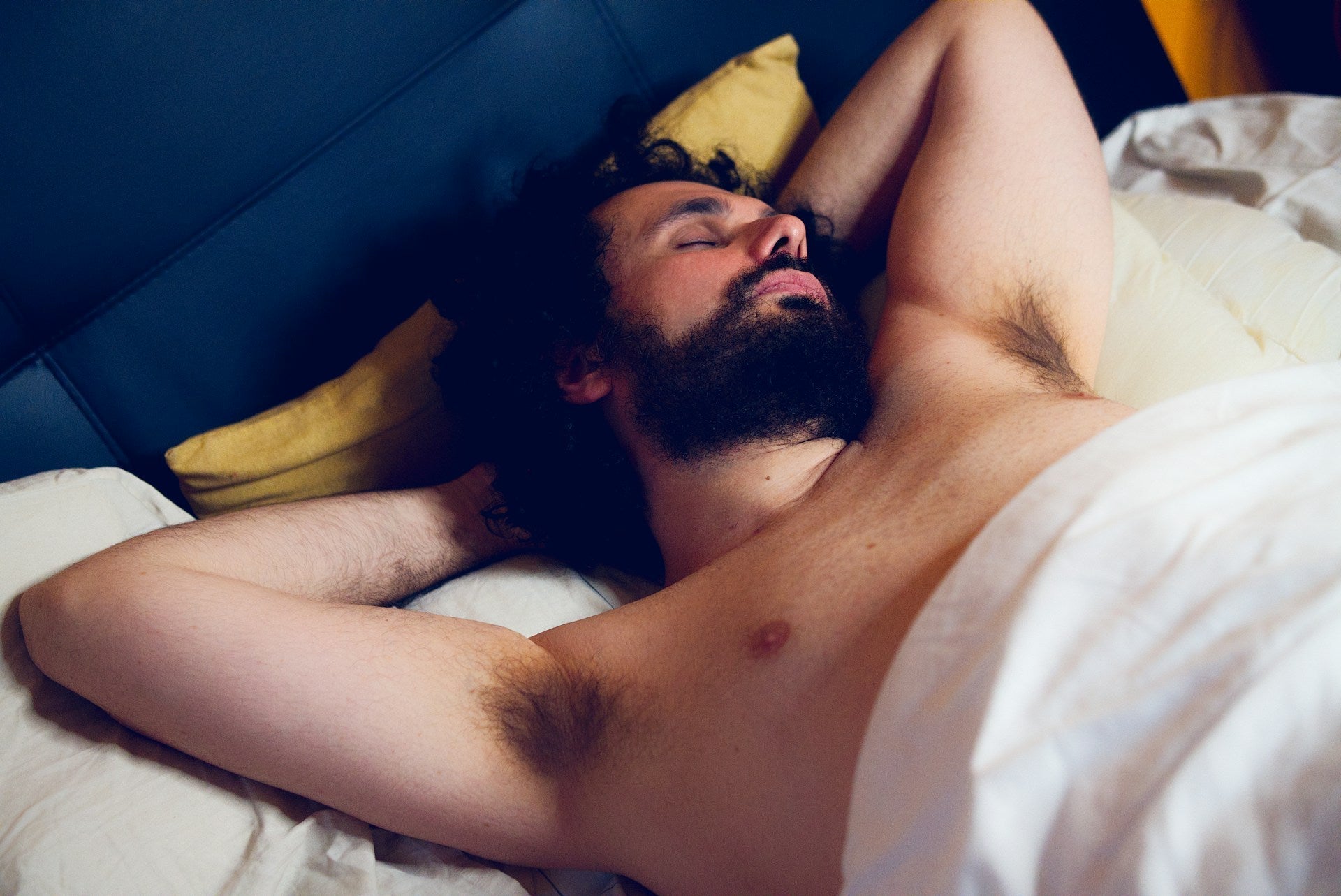 A man in his 30s looking tired and reflective, representing the effects of declining testosterone levels after age 30