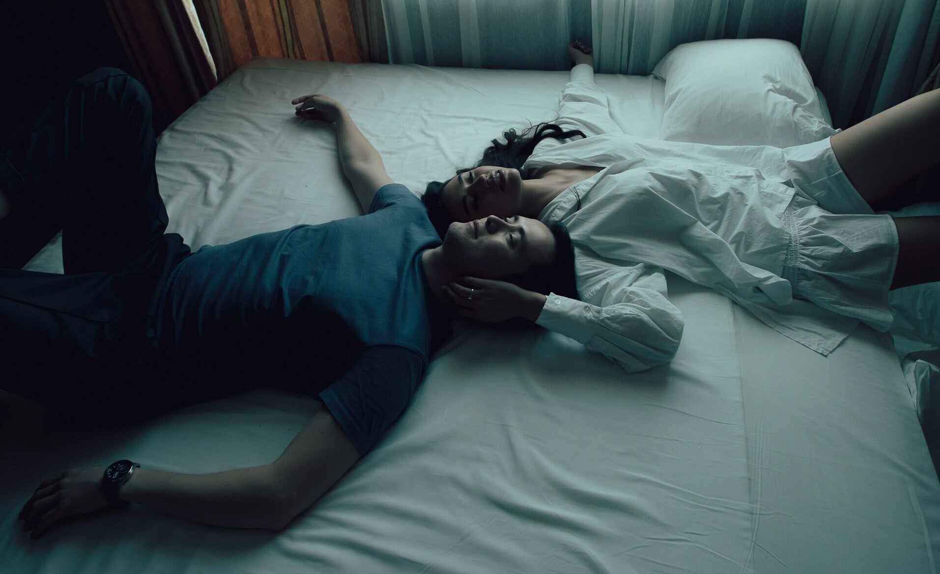 Couple sharing a close and tender moment in bed, illustrating that emotional connection and intimacy matter more than penis size for female orgasm